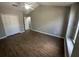 Bedroom featuring wood-look floors, a ceiling fan, and a big closet at 10446 Stone Glen Dr, Orlando, FL 32825