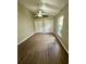 Bedroom featuring wood-look floors, a ceiling fan, and double closet doors at 10446 Stone Glen Dr, Orlando, FL 32825