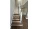 Staircase with painted risers and wood treads, leading to the upper level at 10446 Stone Glen Dr, Orlando, FL 32825