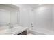 Clean bathroom with a shower-tub combo, a white sink, and white tiled walls at 113 Carlisle Ct, Kissimmee, FL 34758