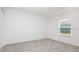 Bright bedroom with neutral carpet, white walls, and a window providing natural light at 113 Carlisle Ct, Kissimmee, FL 34758