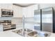 Modern kitchen featuring stainless steel appliances, a double sink, and sleek white cabinets at 113 Carlisle Ct, Kissimmee, FL 34758