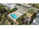 Aerial view of a community pool, playground, and pool house, providing an overview of recreational facilities at 1139 Sand Creek Loop, Ocoee, FL 34761