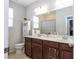 Bathroom with a double sink, a bathtub, and a window at 1139 Sand Creek Loop, Ocoee, FL 34761