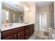 Bathroom with a double sink, a bathtub, and a glass-door shower at 1139 Sand Creek Loop, Ocoee, FL 34761