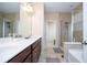 Bathroom with a double sink, a bathtub, and a glass-door shower at 1139 Sand Creek Loop, Ocoee, FL 34761