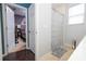 Bright bathroom featuring a neutral shower curtain, beige flooring, and convenient built-in shelving at 1139 Sand Creek Loop, Ocoee, FL 34761