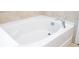 Bright and clean bathtub with a chrome faucet and tile surround at 1139 Sand Creek Loop, Ocoee, FL 34761