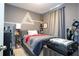 Comfortable bedroom with gray walls, a decorative geometric design, and natural light filtering through curtains at 1139 Sand Creek Loop, Ocoee, FL 34761