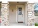 Close up of the front door with decorative wreath and stone pillar accents for a warm, welcoming entry at 1139 Sand Creek Loop, Ocoee, FL 34761