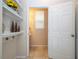 Hallway with white shelving, decor, and doorway leading into a half bathroom with tile flooring at 1139 Sand Creek Loop, Ocoee, FL 34761