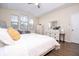 Bright main bedroom with three sunny windows and a white bedroom set and a queen bed at 1139 Sand Creek Loop, Ocoee, FL 34761