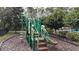 Community playground with climbing equipment and slide, set in a landscaped area at 1139 Sand Creek Loop, Ocoee, FL 34761