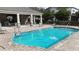 Community pool with covered seating area perfect for enjoying outdoor leisure and relaxation at 1139 Sand Creek Loop, Ocoee, FL 34761