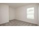 This bedroom has soft neutral carpet, a window with blinds, and is freshly painted at 1304 Congo Dr, Kissimmee, FL 34759