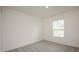 Bright, minimalist bedroom with a window and grey carpet at 1304 Congo Dr, Kissimmee, FL 34759