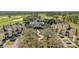 Aerial view of colorful townhouses near a recreational center, golf course, and parking at 1338 Seven Eagles Ct # 302, Reunion, FL 34747