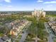 Aerial view of a colorful neighborhood and resort featuring a distant high-rise at 1338 Seven Eagles Ct # 302, Reunion, FL 34747