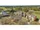 Aerial view of colorful townhouses near a recreational center, golf course, and parking at 1338 Seven Eagles Ct # 302, Reunion, FL 34747