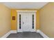 A well-lit entryway features a white front door with sidelights and unit number at 1338 Seven Eagles Ct # 302, Reunion, FL 34747