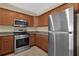 Kitchen area features stainless steel appliances at 1338 Seven Eagles Ct # 302, Reunion, FL 34747