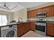 Kitchen area features stainless steel appliances and breakfast bar at 1338 Seven Eagles Ct # 302, Reunion, FL 34747