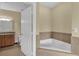 Main bathroom features a soaking tub and granite counters at 1338 Seven Eagles Ct # 302, Reunion, FL 34747