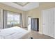 Main bedroom features tile floors and a large window with curtains at 1338 Seven Eagles Ct # 302, Reunion, FL 34747