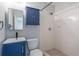 Updated bathroom with a modern blue vanity, hexagon floor tile, and a walk-in shower at 1361 Hobson St, Longwood, FL 32750