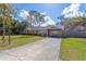 View of the home's well-manicured lawn and a long driveway at 1361 Hobson St, Longwood, FL 32750