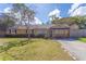 Inviting single-story home with a charming front porch, lush lawn, and beautiful landscaping at 1361 Hobson St, Longwood, FL 32750