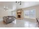 Bright living room featuring a cozy fireplace, neutral sofa, and ample natural light from the windows at 1361 Hobson St, Longwood, FL 32750