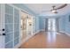 Stylish living room with light blue walls, and French doors leading to the backyard at 1361 Hobson St, Longwood, FL 32750