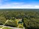 Gorgeous aerial view of the estate with its private pond, circular driveway, and mature trees at 1780 Old Mission Rd, Edgewater, FL 32132