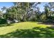 Expansive backyard with lush green grass and mature trees providing ample shade at 1780 Old Mission Rd, Edgewater, FL 32132