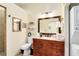 Well-lit bathroom featuring a spacious vanity, toilet, and convenient washer/dryer at 1780 Old Mission Rd, Edgewater, FL 32132