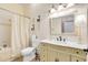 Well-appointed bathroom with custom vanity, ornate mirror, and shower-tub combination at 1780 Old Mission Rd, Edgewater, FL 32132