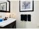 Modern bathroom with a dark wood vanity and a sleek white countertop sink at 1780 Old Mission Rd, Edgewater, FL 32132