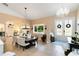 Inviting dining room with elegant chandelier, large windows and easy access to kitchen and entryway at 1780 Old Mission Rd, Edgewater, FL 32132