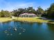 Expansive property featuring a large pond with a fountain and a well-maintained home with a long driveway at 1780 Old Mission Rd, Edgewater, FL 32132