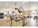 Spacious kitchen with center island, stainless steel appliances, hanging pot rack, and travertine floors at 1780 Old Mission Rd, Edgewater, FL 32132