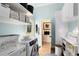 Functional laundry room with washer, dryer, ample storage, and blue accent wall at 1780 Old Mission Rd, Edgewater, FL 32132