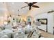 Bright living room with neutral furniture, large windows, high ceilings, and ceiling fan at 1780 Old Mission Rd, Edgewater, FL 32132