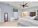 Serene main bedroom with a ceiling fan, soft lighting, and ensuite bathroom access at 1780 Old Mission Rd, Edgewater, FL 32132