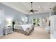 Comfortable main bedroom with tray ceiling, ceiling fan, and sliding glass doors to the backyard at 1780 Old Mission Rd, Edgewater, FL 32132