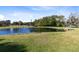 Picturesque pond surrounded by lush greenery, offering a tranquil and scenic view at 1780 Old Mission Rd, Edgewater, FL 32132