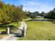 Gated property featuring a winding driveway, beautiful pond, and lush green landscaping at 1780 Old Mission Rd, Edgewater, FL 32132