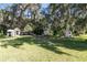 Spacious yard with mature trees, offering shade and serene outdoor space at 1780 Old Mission Rd, Edgewater, FL 32132