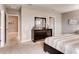 Bedroom featuring a large dresser, carpet, and a large bed with striped sheets at 1839 Waggoner St, Kissimmee, FL 34744