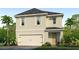 Two-story home with a two-car garage, neutral stucco exterior, complemented by lush landscaping and a paver driveway at 1839 Waggoner St, Kissimmee, FL 34744